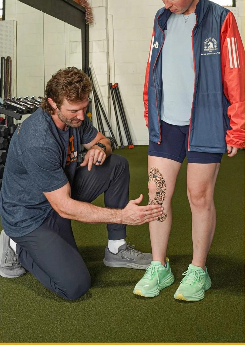 Dr. Nate Leer assessing a runner’s leg